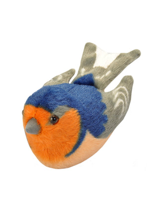 A stuffed version of a barn swallow bird in orange, blue and gray, flying right to left.