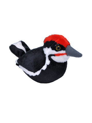 A stuffed animal version of a woodpecker with a black breast and back, and bright red on the crown of its head., facing right