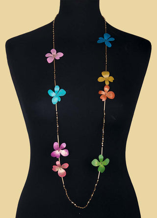 Multicolored brass flowers on a necklace, posed on a black mannequin.