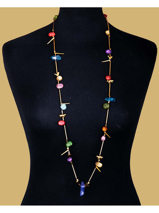 Multicolored stones on a bronze necklace, on a black mannequin.