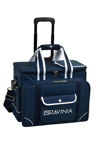 A blue canvas cooler with the Ravinia name and logo in white on the front, and a black wheeled cart behind.