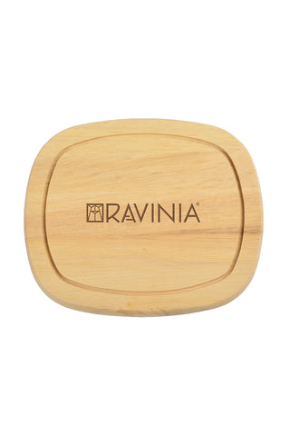 A wooden cutting board with the Ravinia name and logo on it.