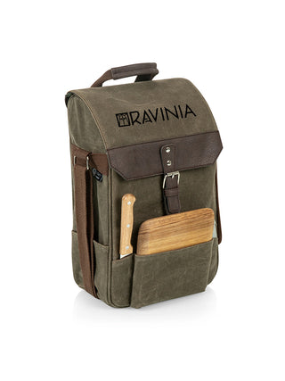 A Ravinia branded canvas bag with a wooden cutting board, a cheese knife, and a corkscrew in its front pockets.