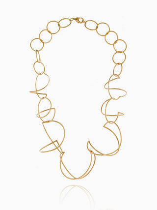 A necklace made of various sizes of brass loops against a white background.