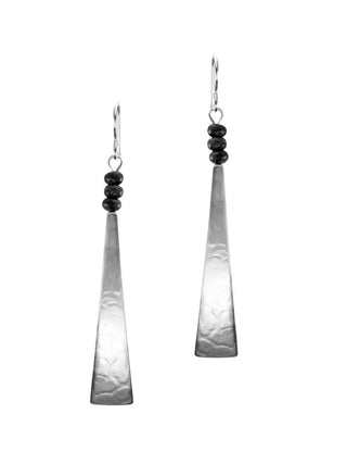 A pair of long, silver triangular earrings with three black beads at the top of each.