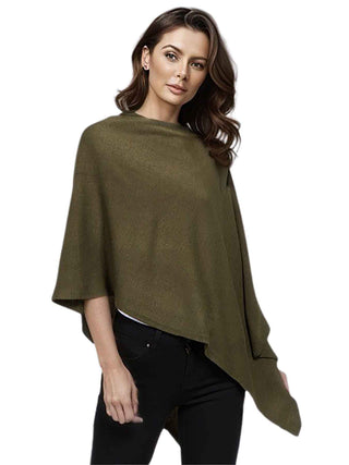 A model in an olive-colored fabric poncho and black pants.