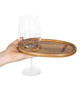 A hand holding a wooden tray with a wine glass in a slot, and RAVINIA branded into the other ends.