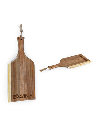 Two wooden boards with handles at their ends, one standing up and one angled to the side, both with RAVINIA branded near the edge.