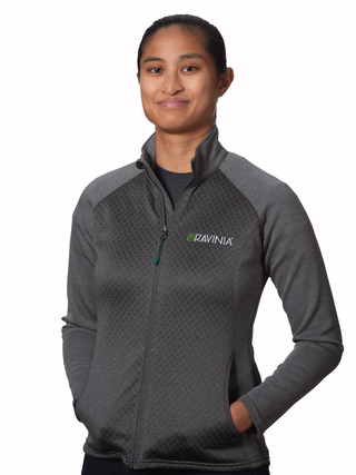 A woman wearing a gray quarter zip pullover with a bright green Ravinia logo and the word RAVINIA in white on the chest, 