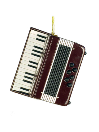 An ornament that looks like a burgundy accordion, with a gold cord for hanging.