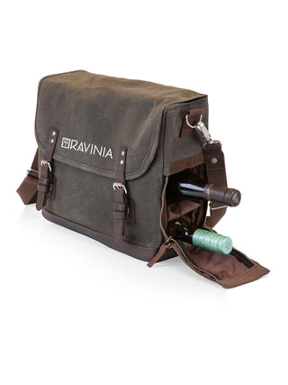 A green waxed cotton tote with RAVINIA printed on it in white,  and the side zipped open to reveal two wine bottles.