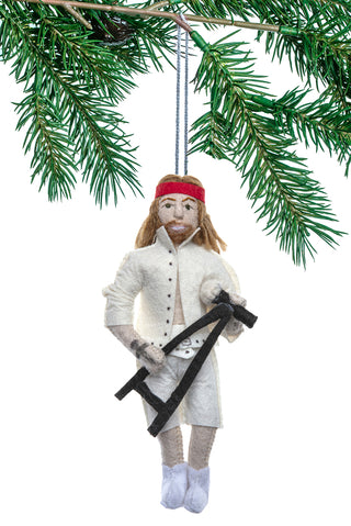 A felt ornament depcting Axl Rose, complete with red handband and microphone, with a Christmas tree branch in the background.