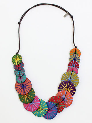 A flat necklace of Round multicolored wooden beads that are layered together and complemented by multiple thread colors that wraps around each bead, on an adjustable cord.