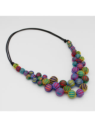 Angled view of a A necklace with multicolor beads, expertly wrapped and closely knotted for a luxurious and exclusive look, on a leather chain..