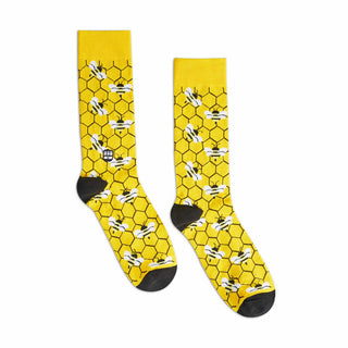 Yellow and black socks with a honeycomb pattern and bees.