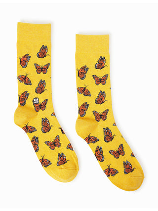 A pair of yellow socks with an orange monarch butterfly pattern.