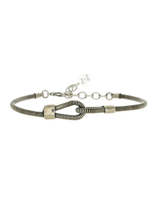 A silver bracelet made out of a bass guitar string, with loops in front and extender chain in back.