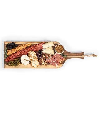 Overhead view of a wooden plank covered with meats and cheese, with only the handle visible.