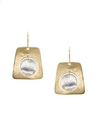 Earrings with a brass cutout tapered rectangle with a silver-toned disc hanging in the center. 