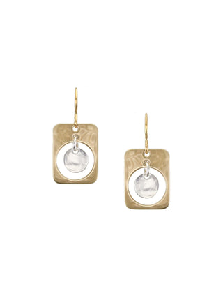 Earrings with a brass cutout rounded rectangle with a silver-toned disc hanging in the center. 