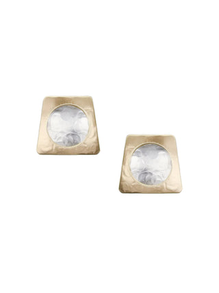 Earrings with a brass tapered rectangle with a cutout in the middle layered over a dished silver-toned disc.