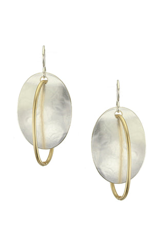 Oval silver-toned earrings with circles of brass wire running through them.