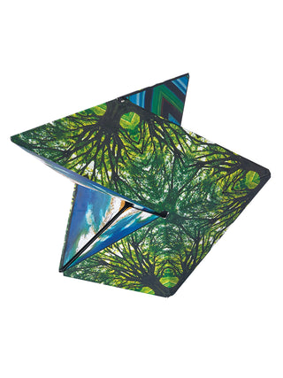 A green geometric shape feature a design of swirling tree branches.