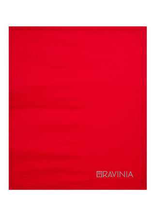 A red blanket with the word Ravinia and the Ravinia logo in gray in the lower right hand corner.