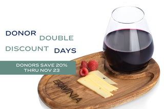 A wooden plate with the Ravinia logo on it, holding a wine glass, cheese and raspberries, next to the text DONOR DOUBLE DISCOUNT DAYS and DONORS SAVE 20% THRU NOV 23.