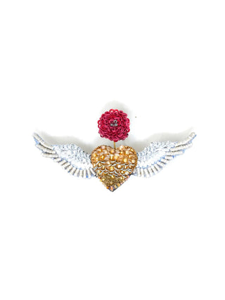 A bejeweled brooch pin in the shape of a gold heart with white wings, with a red flower growing from the center.
