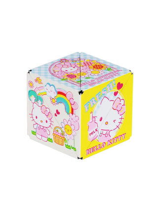 A white, blue, and yellow puzzle box toy with various pictures of Hello Kitty with flowers.