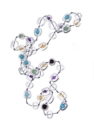 A necklace with silver-toned geo shapes filled with different colored beads, styled in a zig-zag pattern.