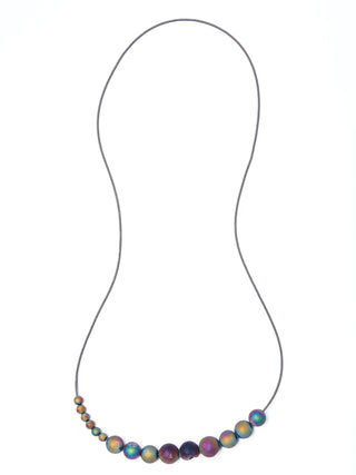 A necklace with geode beads hainging from a wire chain