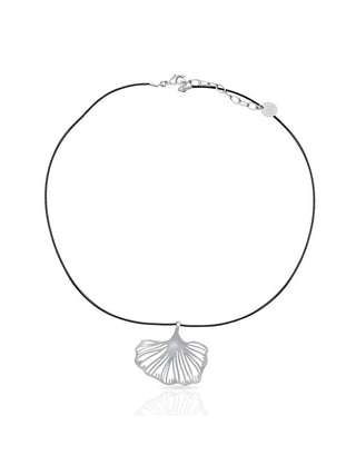 A silver pendant in the shape of a gingko leaf on a black cord.
