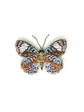 A bejeweled brooch pin in the shape of glorious purplewing butterfly.