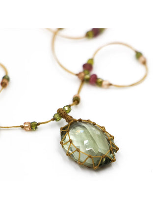 A focused shot of the green amethyst pendant on the necklace.