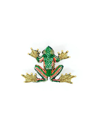 A bejeweled brooch in the shape of a green frog.