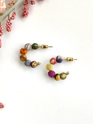 A pair of half hoop post earrings made of 6 wooden beads wrapped in colorful Kantha fabrics.