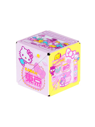 A pink and yellow puzzle box toy with Hello Kitty.