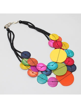 Angled view of a three strands of beads made from both resin and wood in a bright mix of colors are hung from a lobster-claw clasp.