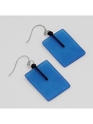 A pair of translucent blue, rectangular earrings, at an angle, with silver-toned hooks.