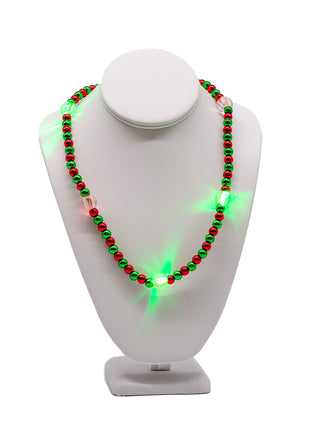 A red and green beaded necklace on a form, with segments that light up.