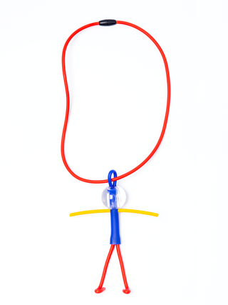 A necklace with a red chain and a little man pendant comprised of blue, yellow and red, with a clear head.