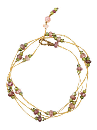 The strand of pink tourmaline beads coiled as a bracelet or anklet.