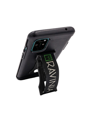 A black phone case with a black LoveHandle phone grip on the back, propped open as a phone stand.