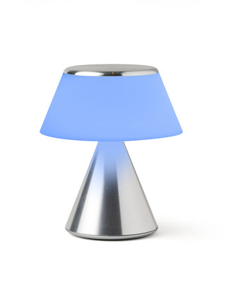 A lamp with a triangular aluminum base and an illuminated  blue shade.