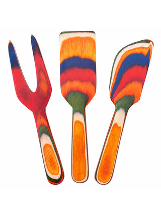 Three wooden cheese tools in vibrant colors.