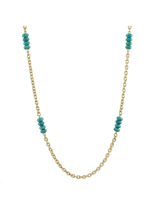 A long brass link chain necklace interspersed with four turquoise bead stacks. 