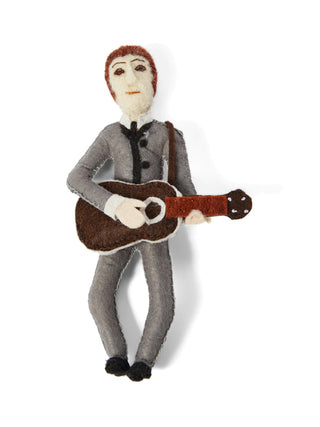 A felt ornament of a young John Lennon with a gray suit on, playing a guitar.