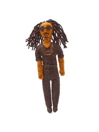 A holiday ornament depicting Stevie Wonder, hanging from a holiday tree branch.